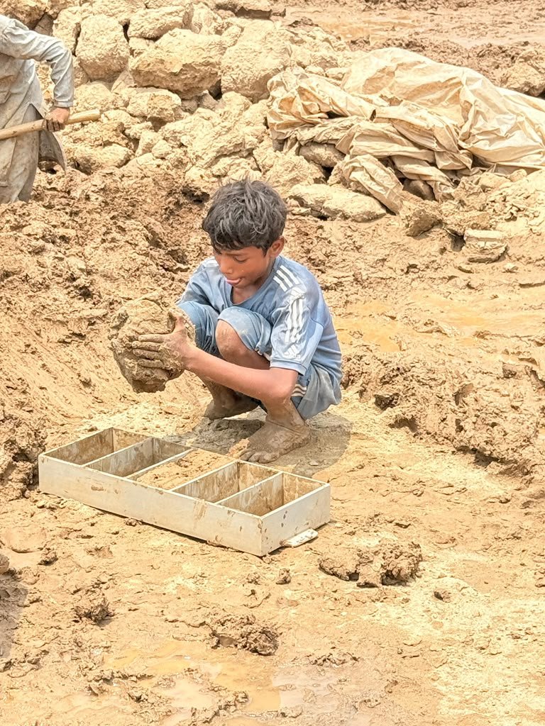 Child working at a brick kiln