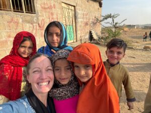 Dehar team member with children in Pakistan